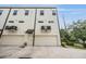 Modern townhouse exterior featuring a two-car garage, clean lines, and contemporary design at 6904 S Macdill Ave # 1, Tampa, FL 33611