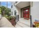 Modern home entrance with a red door, landscaped garden, and contemporary design elements at 6904 S Macdill Ave # 1, Tampa, FL 33611