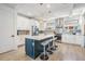 Beautiful kitchen with white cabinets, stainless steel appliances, a navy island with seating, and stylish pendant lights at 6904 S Macdill Ave # 1, Tampa, FL 33611