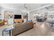 Open-concept living area with a comfortable couch, shelving units, and views of the kitchen and dining area at 6904 S Macdill Ave # 1, Tampa, FL 33611