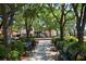 Charming town square with benches, a fountain, lush trees, and surrounding shops at 6904 S Macdill Ave # 1, Tampa, FL 33611