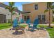 Inviting backyard featuring a brick patio, Adirondack chairs, fire pit, and neatly manicured lawn at 7023 Montauk Point Xing, Bradenton, FL 34212