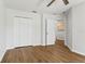 Bright bedroom features wood-look flooring, white walls, and a closet for ample storage at 7023 Montauk Point Xing, Bradenton, FL 34212