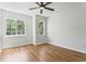 Bedroom showcasing hardwood floors, a modern ceiling fan, and multiple windows for natural light at 7023 Montauk Point Xing, Bradenton, FL 34212