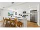 Modern kitchen with white cabinets, stainless steel appliances, quartz countertops, and island with bar seating at 7023 Montauk Point Xing, Bradenton, FL 34212