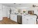 Spacious kitchen featuring white cabinetry, stainless steel appliances, and a large island with modern finishes at 7023 Montauk Point Xing, Bradenton, FL 34212
