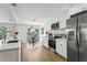 Bright and airy kitchen with white cabinets, stainless steel appliances, and a dining area with a view of the water at 7023 Montauk Point Xing, Bradenton, FL 34212