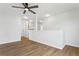 Bright living room features hardwood floors, white walls, and a ceiling fan at 7023 Montauk Point Xing, Bradenton, FL 34212