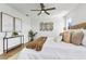 Comfortable main bedroom features a ceiling fan, a side table and nice decorations at 7023 Montauk Point Xing, Bradenton, FL 34212