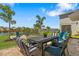 Relaxing patio space with a table, seating, and views of a serene lake and lush landscaping at 7023 Montauk Point Xing, Bradenton, FL 34212