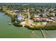 An aerial view displays the property near the water and landscaped neighborhood at 7085 Sunset S Dr # A, St Petersburg, FL 33707