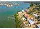Aerial view showcases the property's waterfront location, lush landscaping, and dock at 7085 Sunset S Dr # A, St Petersburg, FL 33707