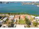 An aerial view shows the property and pool from above near waterfront at 7085 Sunset S Dr # A, St Petersburg, FL 33707