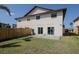 Large backyard with privacy fence, mature trees, and sliding glass door access to the home at 7085 Sunset S Dr # A, St Petersburg, FL 33707