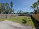 Fully fenced backyard with well-maintained grass, mature trees, and ample space for outdoor activities at 7085 Sunset S Dr # A, St Petersburg, FL 33707