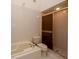 Bright bathroom featuring a glass shower, a soaking tub, and tile throughout at 7085 Sunset S Dr # A, St Petersburg, FL 33707