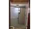 Standard bathroom with tiled walls, sliding glass shower doors, toilet and natural light at 7085 Sunset S Dr # A, St Petersburg, FL 33707