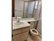 Standard bathroom with tiled floor, tiled shower, vanity, toilet and a large mirror at 7085 Sunset S Dr # A, St Petersburg, FL 33707