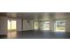 Large bonus room featuring ample natural light from the multiple sliding glass doors to the backyard at 7085 Sunset S Dr # A, St Petersburg, FL 33707