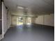 Large bonus room with dual ceiling fans and sliding glass doors leading to the backyard at 7085 Sunset S Dr # A, St Petersburg, FL 33707