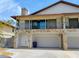 Two-story home with stone accents, upper balcony, and a three-car garage at 7085 Sunset S Dr # A, St Petersburg, FL 33707