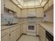Efficient kitchen featuring light cabinetry, neutral countertops, and all appliances at 7085 Sunset S Dr # A, St Petersburg, FL 33707