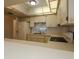 Bright eat-in kitchen with light cabinets, tiled backsplash, and all appliances including refrigerator at 7085 Sunset S Dr # A, St Petersburg, FL 33707