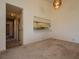 Bright living room with neutral carpet and natural light with open view of the breakfast bar and kitchen at 7085 Sunset S Dr # A, St Petersburg, FL 33707