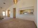 Cozy living room featuring neutral carpet, natural light and a pass-through view to the kitchen at 7085 Sunset S Dr # A, St Petersburg, FL 33707