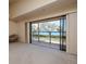 Bright living room with water view and sliding glass doors at 7085 Sunset S Dr # A, St Petersburg, FL 33707