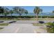 Street view of water across the street and palm trees at 7085 Sunset S Dr # A, St Petersburg, FL 33707