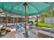 Inviting backyard deck features comfortable seating, an umbrella, and a view of the screened-in porch at 716 75Th N St, St Petersburg, FL 33710