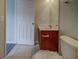 Bathroom with wooden vanity, mirror and door open to the bedroom at 8531 Trail Wind Dr, Tampa, FL 33647