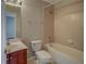 Bathroom with combined shower and bathtub, wooden vanity and ceramic tiles at 8531 Trail Wind Dr, Tampa, FL 33647