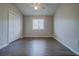 This bedroom offers wood floors, a ceiling fan, and a window for natural light at 8531 Trail Wind Dr, Tampa, FL 33647