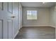 This bedroom offers wood floors, a ceiling fan, and a window for natural light at 8531 Trail Wind Dr, Tampa, FL 33647