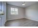 This bedroom offers wood floors, a ceiling fan, and a window for natural light at 8531 Trail Wind Dr, Tampa, FL 33647