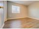 Bright bedroom with wood-look flooring, a window, and a closet at 8531 Trail Wind Dr, Tampa, FL 33647