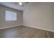This bedroom offers wood floors and a window for natural light at 8531 Trail Wind Dr, Tampa, FL 33647