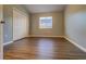 Bedroom featuring wood-look floors, a window, and a closet at 8531 Trail Wind Dr, Tampa, FL 33647