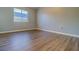 This bedroom offers wood floors and a window for natural light at 8531 Trail Wind Dr, Tampa, FL 33647