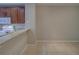 Kitchen with wood cabinets, beige countertops, and white appliances at 8531 Trail Wind Dr, Tampa, FL 33647