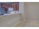 Kitchen boasts stainless steel refrigerator, white microwave and oven, and wood cabinets at 8531 Trail Wind Dr, Tampa, FL 33647