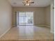 Spacious living room with tile flooring and sliding glass doors to outdoor space at 8531 Trail Wind Dr, Tampa, FL 33647