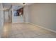 Open-concept living room with tile floors flowing into the kitchen area at 8531 Trail Wind Dr, Tampa, FL 33647