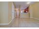 Neutral open-concept living space featuring tile floors that leads to the front door and kitchen at 8531 Trail Wind Dr, Tampa, FL 33647