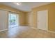 Bright living room with tan walls, tile floors, and sliding glass door to an enclosed patio at 8531 Trail Wind Dr, Tampa, FL 33647