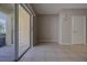 Living room featuring neutral walls, tile floors, and access to outdoor space through sliding glass doors at 8531 Trail Wind Dr, Tampa, FL 33647