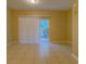 Bright living room showcasing tile flooring and sliding glass doors to the patio at 8531 Trail Wind Dr, Tampa, FL 33647