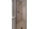 Shower stall features glass doors, tan tile, and an adjustable shower head at 8531 Trail Wind Dr, Tampa, FL 33647